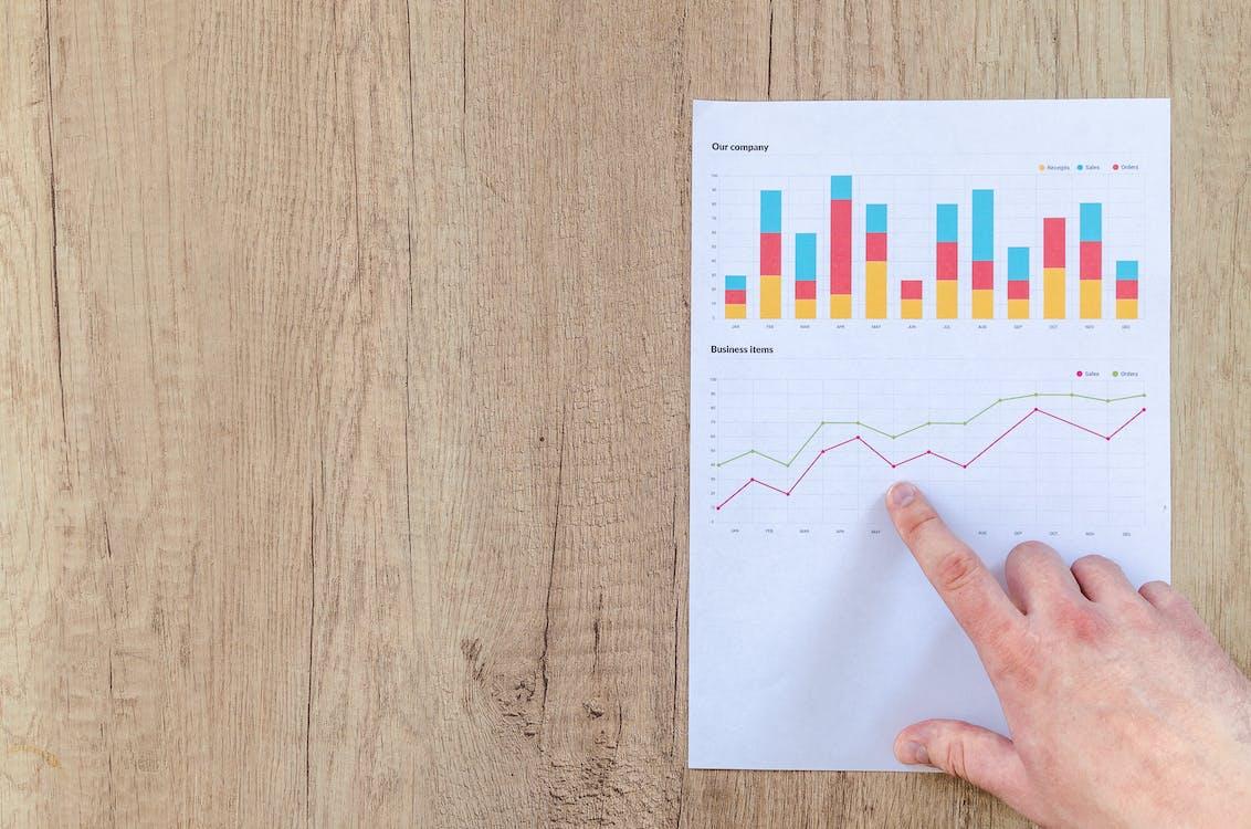 Free Person Pointing Paper Line Graph Stock Photo