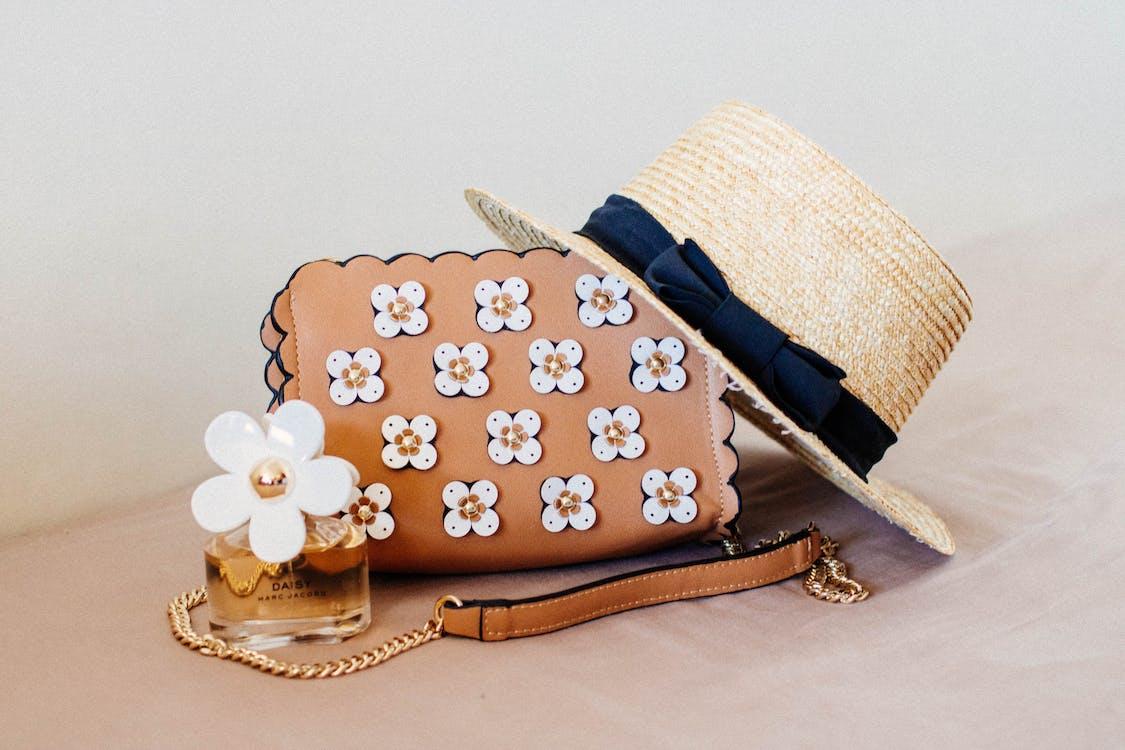 Free Brown Sun Hat On Brown And White Floral Sling Bag Stock Photo